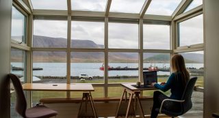 Remote working at home with a picturesque view out to a small harbour.